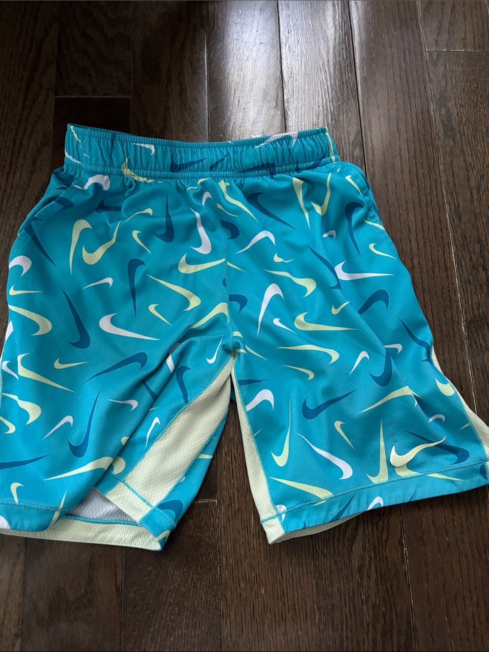 Nike Teal Athletic Shorts with Yellow & White Swoosh Print